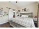 Main bedroom featuring a king-size bed, barn door to bathroom and decorative wall at 10605 58Th E St, Parrish, FL 34219