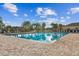 Community pool with a spacious deck area and lounge chairs at 10605 58Th E St, Parrish, FL 34219