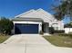 House exterior with a navy blue garage door at 11814 53Rd E Ct, Parrish, FL 34219