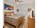 King-size bedroom with wood flooring and large beach-themed art at 1188 N Tamiami Trl # 203, Sarasota, FL 34236