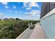 Brick paved walkway to a waterfront patio with lush landscaping at 1215 Acappella Ln, Apollo Beach, FL 33572