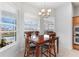 Bright breakfast nook with wood table and chairs, overlooking pool at 1215 Acappella Ln, Apollo Beach, FL 33572