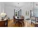 Formal dining room featuring hardwood floors and a glass-top table at 1215 Acappella Ln, Apollo Beach, FL 33572