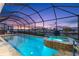Stunning nighttime view of a heated pool and spa at 1215 Acappella Ln, Apollo Beach, FL 33572