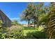 Large backyard with canal view, lush landscaping, and a spacious lawn at 1269 Western Pine Cir, Sarasota, FL 34240
