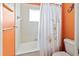 Bathroom with shower/tub combo and orange walls at 1269 Western Pine Cir, Sarasota, FL 34240