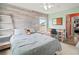 Bedroom with wood-like accent wall and workspace at 1269 Western Pine Cir, Sarasota, FL 34240