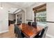 Dining room with dark wood table and black chairs, overlooking the pool at 1269 Western Pine Cir, Sarasota, FL 34240