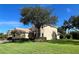 Two-story house with tan exterior, landscaping, and a tree in front at 1269 Western Pine Cir, Sarasota, FL 34240