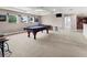 Spacious game room with pool table and large windows at 1269 Western Pine Cir, Sarasota, FL 34240