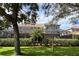 Two-story house with screened lanai and a hedge for privacy at 1269 Western Pine Cir, Sarasota, FL 34240