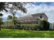 Two-story house with a large backyard, lush landscaping, and a screened lanai at 1269 Western Pine Cir, Sarasota, FL 34240