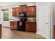 Kitchen with dark wood cabinets, granite counters and black appliances at 1269 Western Pine Cir, Sarasota, FL 34240