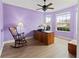 Home office with lavender walls, hardwood floors, and a rocking chair at 1269 Western Pine Cir, Sarasota, FL 34240