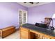 Office with lavender walls, hardwood floors and built-in wooden desk at 1269 Western Pine Cir, Sarasota, FL 34240
