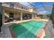 Inviting pool and spa with screened enclosure, outdoor kitchen, and dining area at 1269 Western Pine Cir, Sarasota, FL 34240