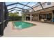 Inviting screened pool area with spacious patio, outdoor kitchen, and dining furniture at 1269 Western Pine Cir, Sarasota, FL 34240