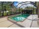 Refreshing screened pool with brick coping and ample patio space at 1269 Western Pine Cir, Sarasota, FL 34240