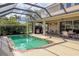 Refreshing pool with screened lanai, outdoor kitchen, and dining furniture at 1269 Western Pine Cir, Sarasota, FL 34240