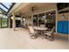 Covered patio with dining table and chairs near the pool at 1269 Western Pine Cir, Sarasota, FL 34240