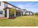 Large backyard with screened patio and grassy area at 13891 Heartwood Way, Parrish, FL 34219