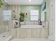 Bathroom with a large, oval soaking tub and a walk-in shower at 13891 Heartwood Way, Parrish, FL 34219