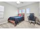 Spacious bedroom with a wooden bed frame, desk and chair at 13891 Heartwood Way, Parrish, FL 34219