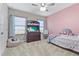 Charming bedroom with a comfortable bed, built-in shelving, and ceiling fan at 13891 Heartwood Way, Parrish, FL 34219
