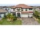 Two story house with tile roof, driveway, and landscaping at 13891 Heartwood Way, Parrish, FL 34219