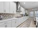 Modern kitchen with white cabinets, quartz countertops and geometric backsplash at 13891 Heartwood Way, Parrish, FL 34219