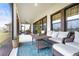 Screened patio with comfortable seating area at 13891 Heartwood Way, Parrish, FL 34219