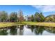 A home's backyard featuring a pond and lush landscaping at 14912 Bowfin Ter, Lakewood Ranch, FL 34202