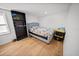 Bright bedroom with a queen-size bed and wood floors at 1518 Ewing Ave, Clearwater, FL 33756