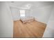 Simple bedroom with a double bed and wood floors at 1518 Ewing Ave, Clearwater, FL 33756