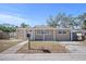 Tan house with a covered porch and a well-maintained lawn at 1518 Ewing Ave, Clearwater, FL 33756