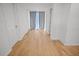 Bright hallway with light wood floors and access to other rooms at 1518 Ewing Ave, Clearwater, FL 33756