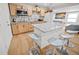 Modern kitchen with granite island, light wood cabinets, and stainless steel appliances at 1518 Ewing Ave, Clearwater, FL 33756