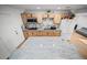 Modern kitchen with granite island and light wood cabinets at 1518 Ewing Ave, Clearwater, FL 33756