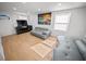 Living room with gray couches, light wood floors, TV and fireplace at 1518 Ewing Ave, Clearwater, FL 33756
