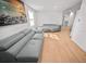 Living room with gray couches, light wood floors and large artwork at 1518 Ewing Ave, Clearwater, FL 33756