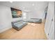 Living room with gray couches, light wood floors and large artwork at 1518 Ewing Ave, Clearwater, FL 33756
