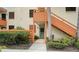 Orange stairs leading to condo entrance with landscaping at 153 Wild Palm Dr # 153, Bradenton, FL 34210