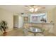 Charming dining area with glass-top table and seating for four, adjacent to the kitchen at 153 Wild Palm Dr # 153, Bradenton, FL 34210