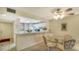 Bright dining area with glass-top table and seating for four, adjacent to kitchen at 153 Wild Palm Dr # 153, Bradenton, FL 34210