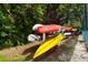Colorful kayaks are stored on a rack near lush greenery at 153 Wild Palm Dr # 153, Bradenton, FL 34210
