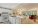 Efficient kitchen with white cabinetry, stainless steel appliances, and breakfast bar at 153 Wild Palm Dr # 153, Bradenton, FL 34210