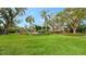 Expansive green lawn with mature trees and landscaping at 153 Wild Palm Dr # 153, Bradenton, FL 34210