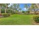 Landscaped lawn with lush greenery and palm trees at 153 Wild Palm Dr # 153, Bradenton, FL 34210