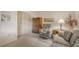Comfortable sitting area with a sofa, recliner, and built-in shelving at 153 Wild Palm Dr # 153, Bradenton, FL 34210