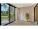 Sunroom with sliding glass doors and view of backyard at 153 Wild Palm Dr # 153, Bradenton, FL 34210